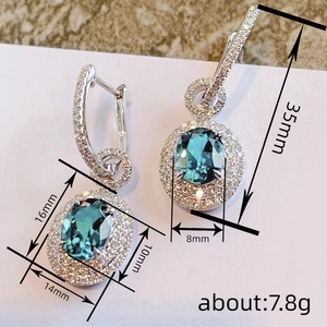Elegant silver leverback earrings with oval blue stone and double halo zircon pavé