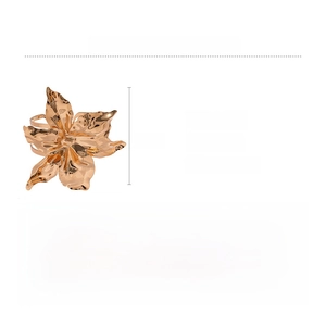 Detailed view of a gold-plated flower napkin ring with rippled petals on white background