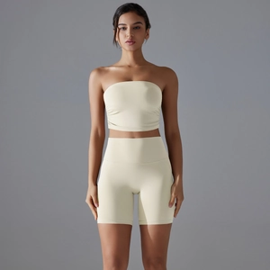 Detail of ruched bandeau top and high-waisted fitness shorts in cream white yoga set