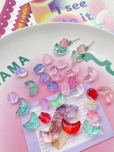 Macro detail of gradient tulip and moon acrylic beads for DIY jewelry making