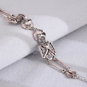 Close-up of vintage punk skeleton bracelet with antique rose gold finish and details