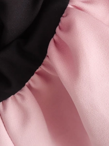 Detail shot showing the contrast stitching and texture of pink and black fabric