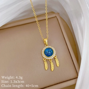 Close-up of gold dreamcatcher necklace with blue gemstone and detailed size dimensions