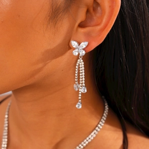 Detailed view of elegant silver butterfly earrings with sparkling cubic zirconia tassels