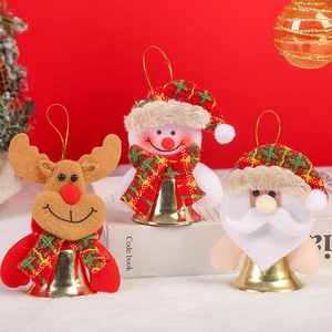 Detail of Christmas tree ornaments featuring Santa, snowman, and reindeer with gold bells