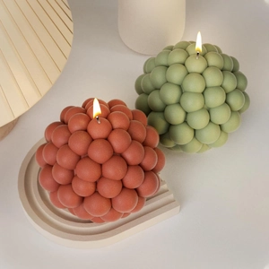 Artistic bubble ball aromatherapy candles in terracotta and sage green colors