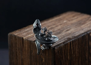 Macro detail of vintage S925 silver lizard ring with red gem eyes and scale texture