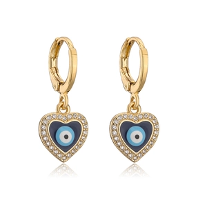 Detail of gold heart earrings with blue evil eye enamel and shimmering crystals