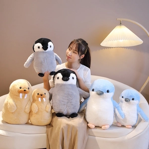 Plush penguin and seal dolls in various sizes shown in a cozy living room setting
