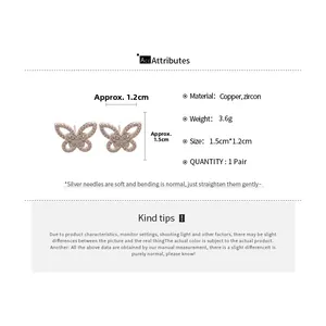 Macro detail of butterfly zircon earrings with dimensions 1.5cm by 1.2cm on white background