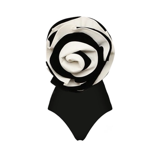 Detail of elegant black bodysuit featuring a large 3D black and white rose design