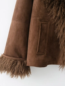 Detail shot of brown faux fur jacket cuff and suede pocket with premium stitching