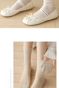 Detail view of high-elasticity ribbed cuffs on sheer light beige knee-high socks