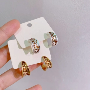 Vintage C-shaped enamel hoop earrings in gold and silver finish with hollow floral design