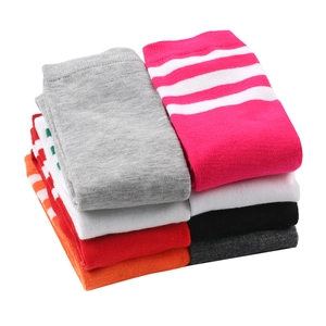 Detail view of colorful folded women's calf socks with classic striped and solid designs