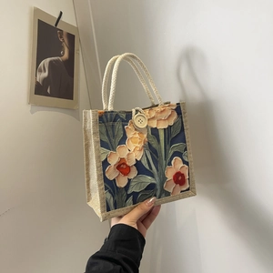 Close-up of floral linen tote bag with bold flower prints and thick rope handle