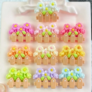 Colorful resin flower fence charms in various pastel shades for DIY crafts and accessories
