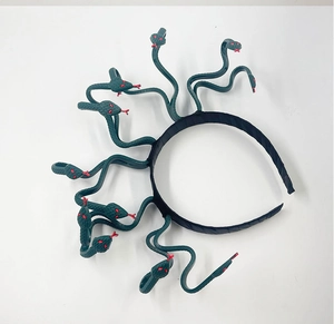 Detail of Medusa headpiece featuring green snakes with red eyes for cosplay costume