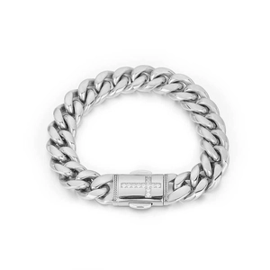 Detail view of silver Cuban link bracelet featuring a sparkling diamond-set cross clasp