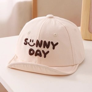 Close-up of baby baseball cap with Sunny Day embroidery and soft brim in beige cotton