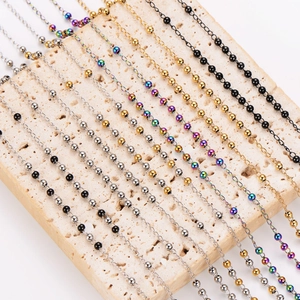 Multi-colored stainless steel geometric pendant necklaces on a natural stone base