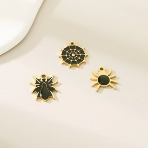 Detail of Halloween spider and cobweb charms with black enamel and gold finish