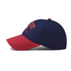 Detailed view of high-quality navy cotton baseball cap with red brim and Boston embroidery