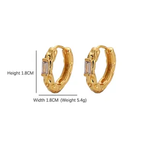 Geometric gold hoop earrings with hammered texture and rectangular zircon stones