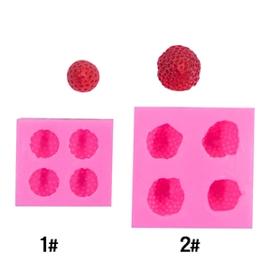 Detail of four-cavity pink silicone strawberry molds with red resin craft samples