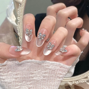 Pink cat-eye handmade press-on nails with 3D rhinestone butterfly and almond shape