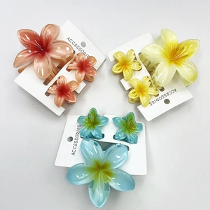 Frangipani hair claw set in pink, yellow, and blue with translucent resin finish