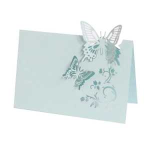 Detailed laser-cut hollow butterfly table card in light blue paper for weddings