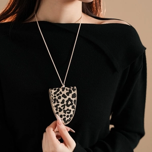 Detail showing faux leather leopard print eyeglass pouch pendant on a beige necklace cord