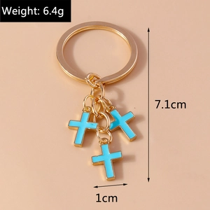 Detailed view of a gold alloy keychain with three blue enamel cross charms and dimensions