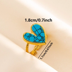 Macro shot of gold heart ring with blue stone and dimension markings 1.8cm by 1.7cm