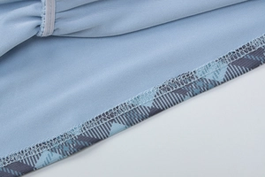 Gros plan sur les coutures et détails d'ourlet du débardeur en maille bleu clair