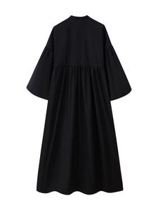Detailed back view of a black pleated loose-fit dress with wide sleeves and clean draping