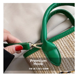 Detailed close-up of green lychee leather handle with gold metal hooks on woven basket bag