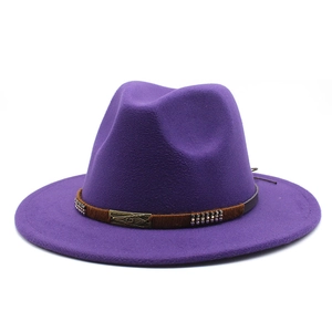 Macro detail of purple wool fedora hat with brown leather band and bronze metal buckle