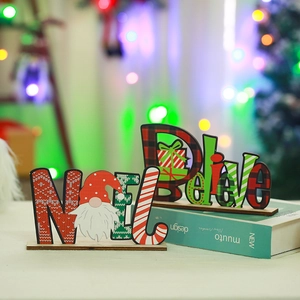 Close-up of wooden Noel and Believe Christmas table decorations with gnome motif