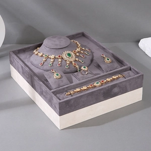 Bohemian gold jewelry set with green teardrop gems in a grey velvet display box