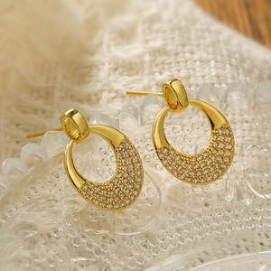 18K gold plated oval earrings featuring micro-paved cubic zirconia on a glass tray