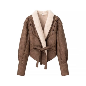 Detail of brown faux suede jacket with cream shearling lining and shoulder lace-up design