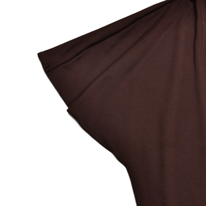 Close-up of deep brown pleated fabric showing smooth texture and elegant drape detail