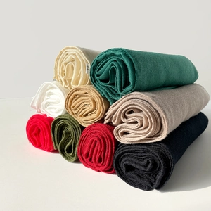 Detailed macro view showing multiple colors of 90cm cotton linen scarf fabric rolls