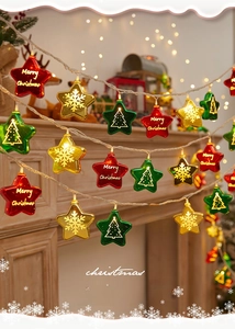 Close-up detail of festive star-shaped Christmas string lights in red green and gold colors