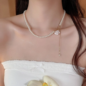 Elegant camellia pearl necklace with golden tassel pendant and drop pearl detail on collarbone