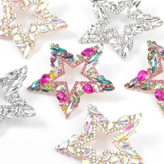 Detailed view of colorful star-shaped rhinestone brooches in various vibrant plating colors