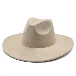 Detailed top view of a beige wide-brim suede fedora with classic center dent crown
