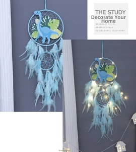 Detail of blue dinosaur dreamcatcher with LED lights, soft feathers and pearl beads